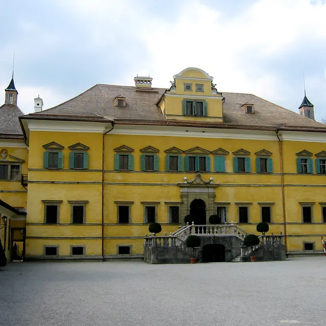 The ochre facade of Schloss Hellbrunn with its double staircase